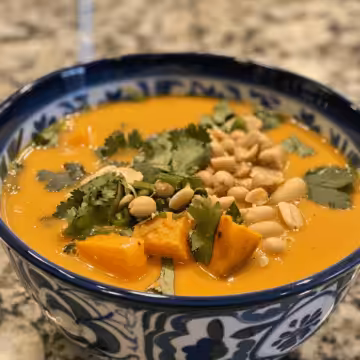 Creamy Peanut Soup with Sweet Potato taken with iphone 15 pro max --iw 2 --ar 4:5 --v 6.0 --raw