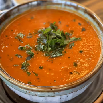Roasted Red Pepper Soup taken with iphone 15 pro max --iw 2 --ar 4:5 --v 6.0 --raw