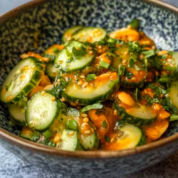 Cucumbers In Spicy Peanut Sauce taken with iphone 15 pro max --iw 2 --ar 4:5 --v 6.1 --raw