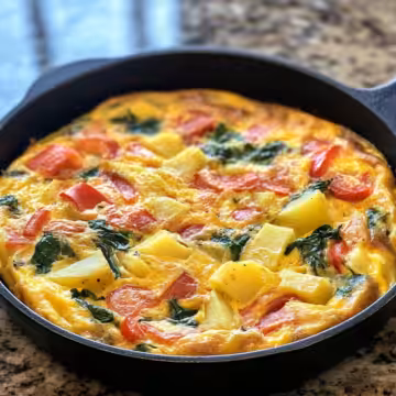 Frittata With Potatoes Red Peppers And Spinach Recipe taken with iphone 15 pro max --iw 2 --ar 4:5 --v 6.1 --raw