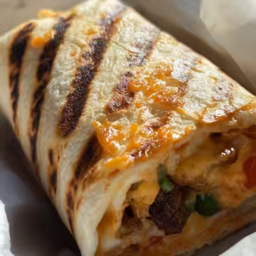 Grilled Cheese Burrito taken with iphone 15 pro max --iw 2 --ar 4:5 --v 6.1 --raw
