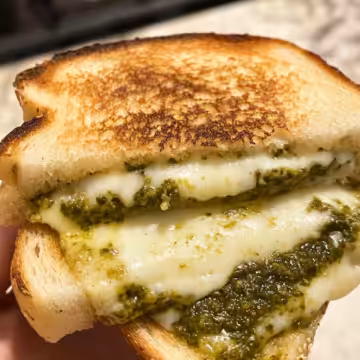 Sourdough Pesto Grilled Cheese taken with iphone 15 pro max --iw 2 --ar 4:5 --v 6.1 --raw