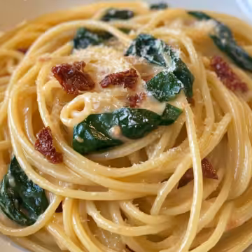 Spaghetti and Spinach with Sun-Dried Tomato Cream Sauce Recipe taken with iphone 15 pro max --iw 2 --ar 4:5 --v 6.1 --raw