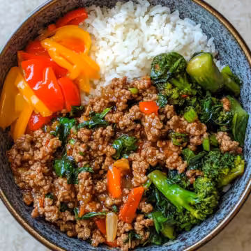 Spicy Ground Beef Stir Fry Bowl With Garlic Veggies Steamy Rice taken with iphone 15 pro max --iw 2 --ar 4:5 --v 6.1 --raw