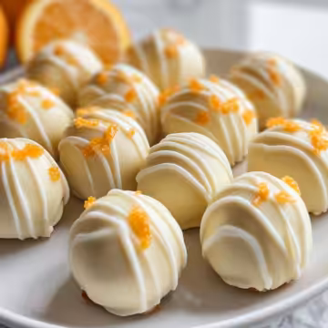 White Chocolate Orange Creamsicle Truffles taken with iphone 15 pro max --iw 2 --ar 4:5 --v 6.1 --raw