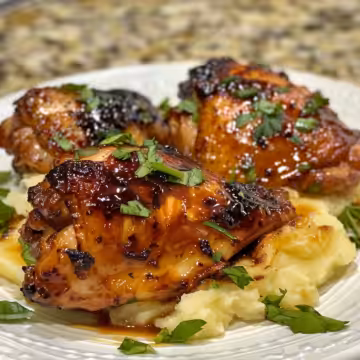 Chipotle Honey Chicken Thighs with Smoked Gouda Mashed Potatoes taken with iphone 15 pro max --iw 2 --ar 4:5 --v 6.0 --raw