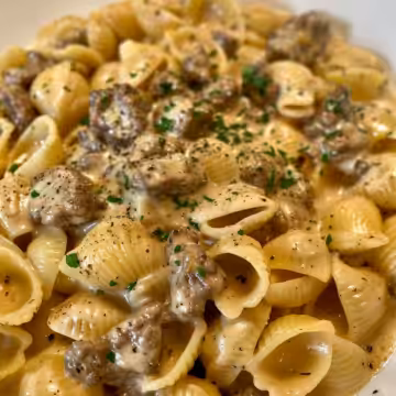 Creamy Beef and Shells Pasta taken with iphone 15 pro max --iw 2 --ar 4:5 --v 6.0 --raw