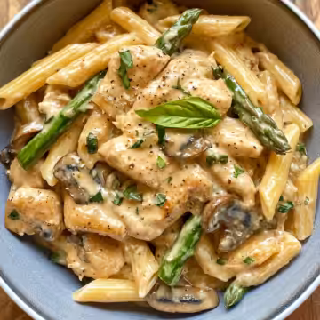 Creamy Mushroom & Asparagus Chicken Penne taken with iphone 15 pro max --iw 2 --ar 4:5 --v 6.1 --raw