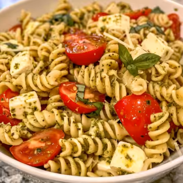 Easy Summer Side Dish Perfect for Potlucks; Pesto Pasta Salad with Tomatoes & Mozzarella taken with iphone 15 pro max --iw 2 --ar 4:5 --v 6.0 --raw