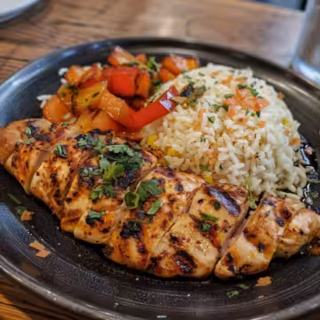 Nando's Portuguese Chicken & Rice taken with iphone 15 pro max --iw 2 --ar 4:5 --v 6.0 --raw