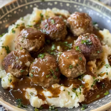 Salisbury Steak Meatballs with Garlic Herb Mashed Potatoes taken with iphone 15 pro max --iw 2 --ar 4:5 --v 6.0 --raw