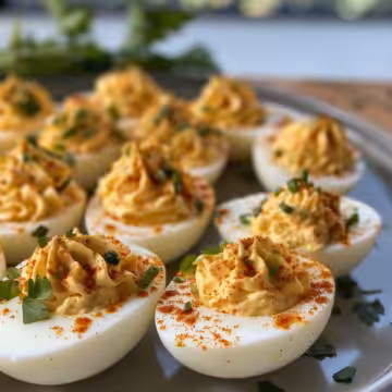 Spicy Chili Garlic Deviled Eggs taken with iphone 15 pro max --iw 2 --ar 4:5 --v 6.0 --raw