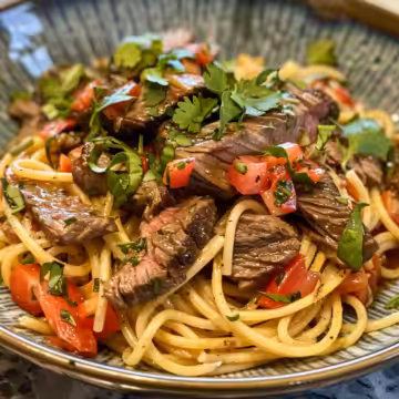 Sweet and Spicy Garlic Steak Pasta taken with iphone 15 pro max --iw 2 --ar 4:5 --v 6.0 --raw